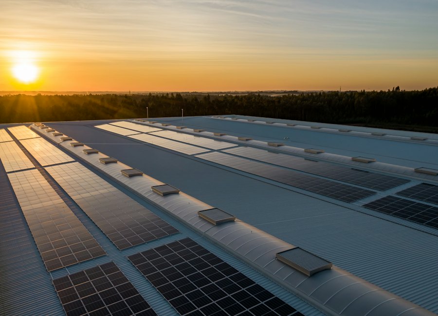Commercial building rooftop with solar array at sunset